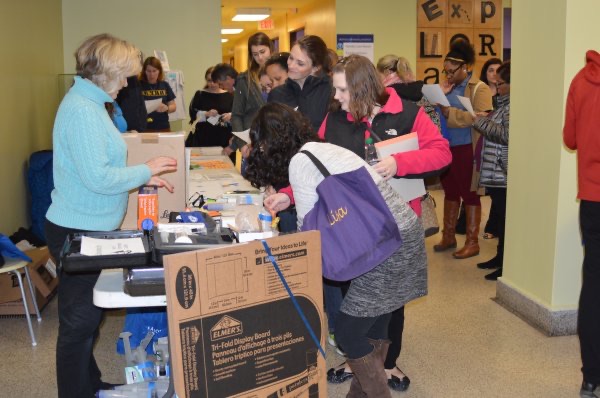 Teachers lined up at a conference registration table